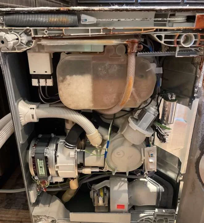 Dishwasher pump, hoses and motor exposed for diagnosis