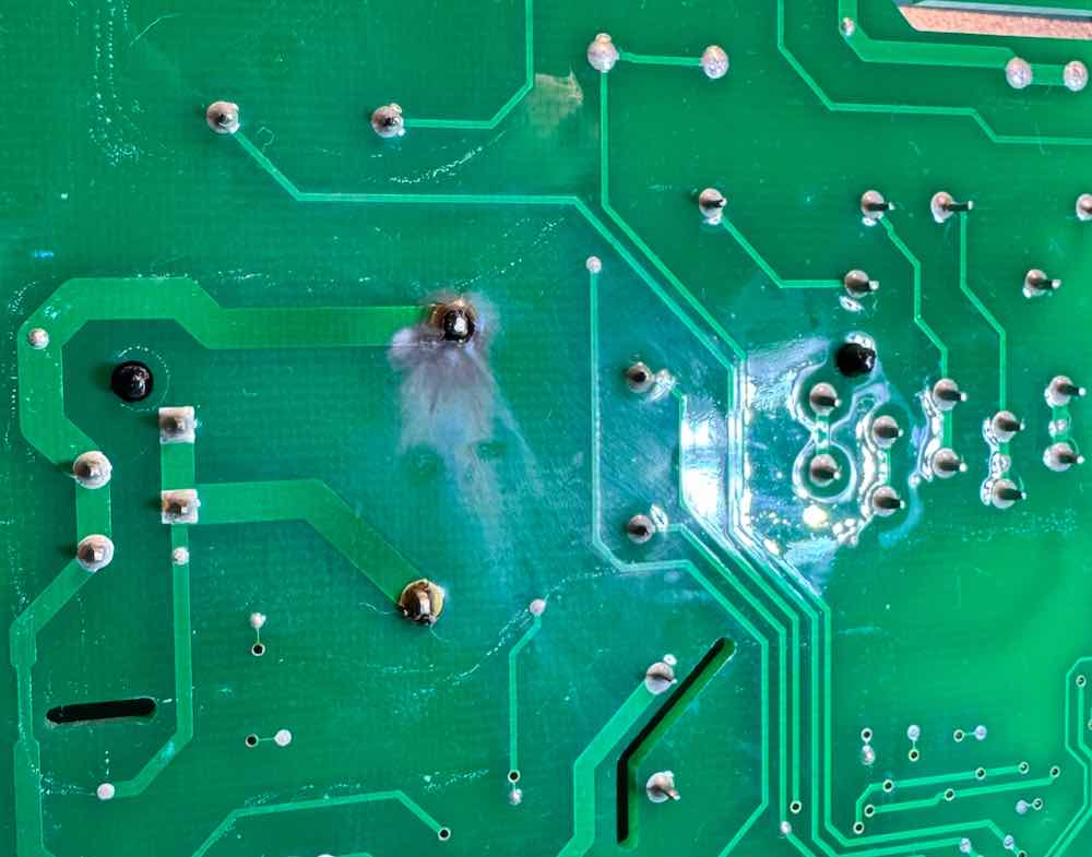 Circuit board examined during electronics repair